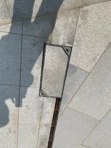 Stainless steel concealed manhole cover flush with stone paving – landscaping hardware by ZEMSS China