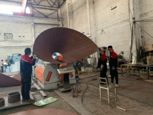 ZEMSS workers operating cone rolling machine to form asymmetric steel cone – precision metal rolling China