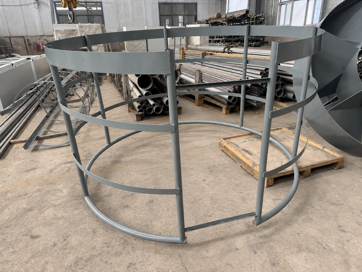 Gray coated access guard cage standing in the project workshop